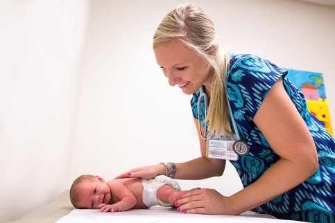 Doctor of Nursing Practice student Mallory McKinnon works with a young patient while on clinical rotations at UF Health Eastside Clinic.
