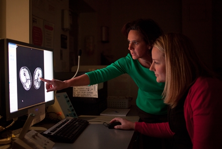 Dr. Krista Vandenborne (left), supported by a $7.15 million NIH grant, leads UF’s studies of the use of MRI to track the disease progression of Duchenne muscular dystrophy. With Dr. Rebecca Wilcox, research assistant scientist, she is shown using the technology to take precise, noninvasive measurements of diseased leg muscle tissue.